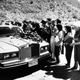 Bhagwan Shree Rajneesh drives his Rolls Royce as cult members throw flowers on his car in July of 1984 (AP Photo/Bill Miller)